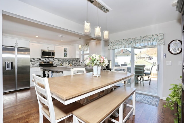 dining area with dark wood-type flooring