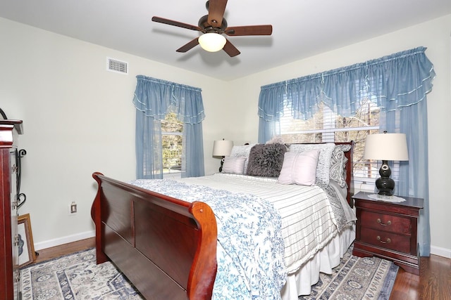 bedroom with baseboards, multiple windows, and visible vents