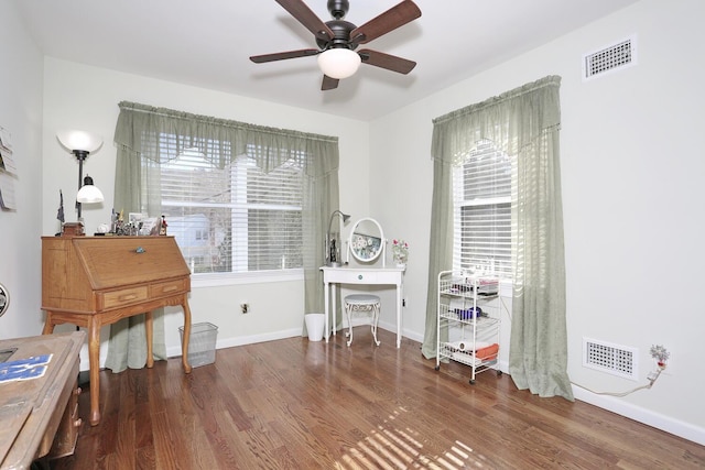 misc room featuring visible vents, baseboards, wood finished floors, and ceiling fan