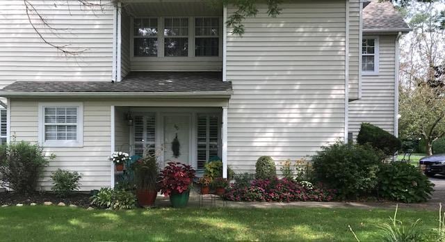 60 Erin Ln Unit 60, East Setauket, NY 11733 - property entrance with a yard