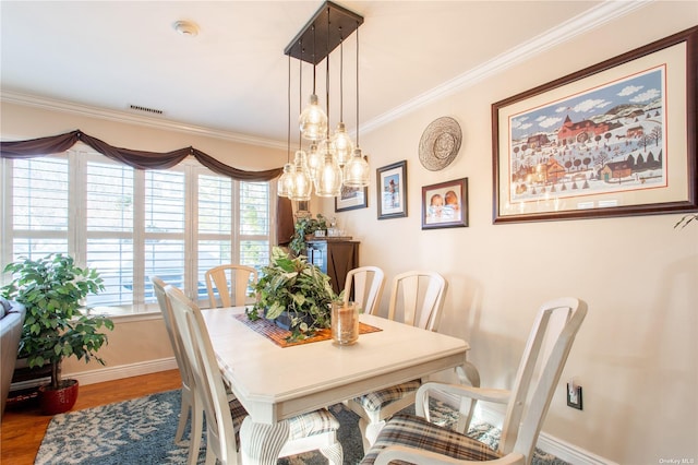 60 Erin Ln Unit 60, East Setauket, NY 11733 - dining space featuring ornamental molding and wood finished floors