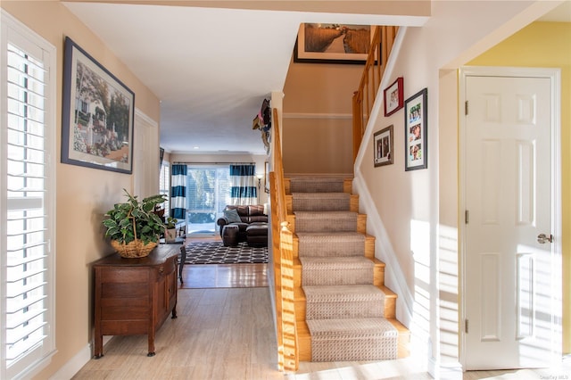 60 Erin Ln Unit 60, East Setauket, NY 11733 - stairs with wood finished floors and baseboards