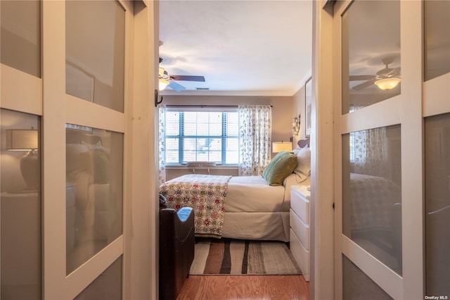 60 Erin Ln Unit 60, East Setauket, NY 11733 - bedroom featuring crown molding, wood finished floors, and a ceiling fan