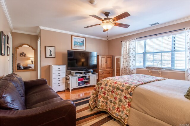 60 Erin Ln Unit 60, East Setauket, NY 11733 - bedroom with crown molding, light wood-style flooring, and ceiling fan