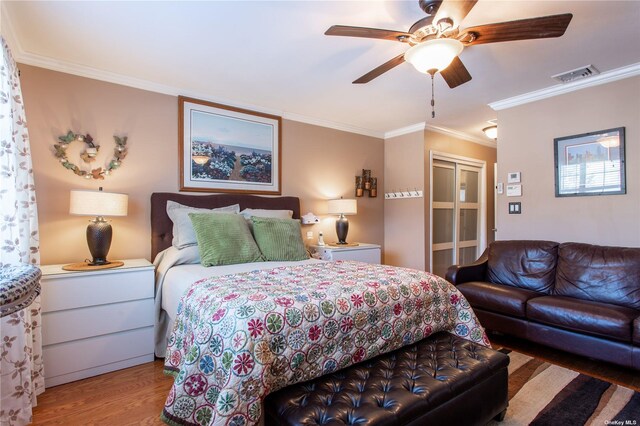 60 Erin Ln Unit 60, East Setauket, NY 11733 - bedroom featuring ornamental molding, wood finished floors, a closet, and a ceiling fan
