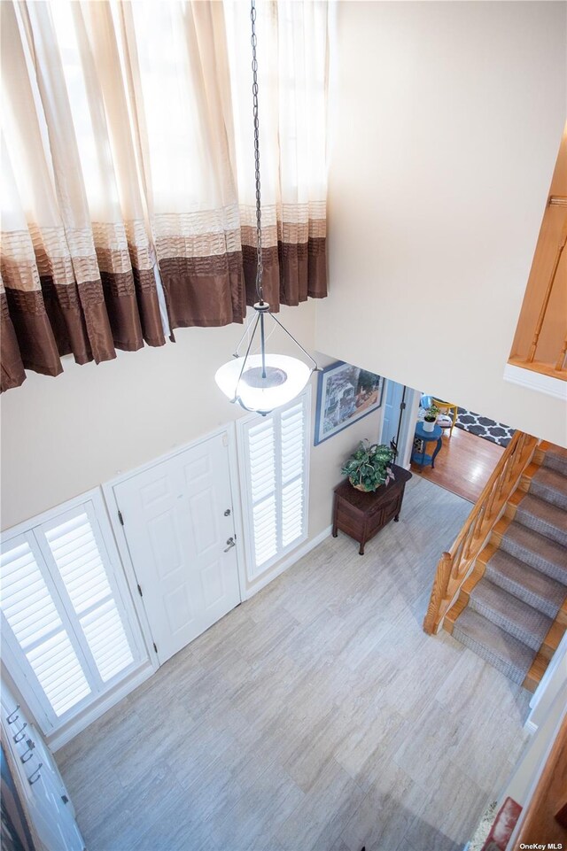 60 Erin Ln Unit 60, East Setauket, NY 11733 - foyer with wood finished floors and a high ceiling