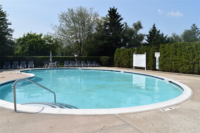 60 Erin Ln Unit 60, East Setauket, NY 11733 - community pool featuring a patio and view of scattered trees