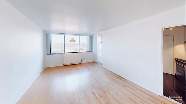 2 Bay Club Dr Unit 6Z4, Bayside, NY 11360 - unfurnished room featuring radiator and wood finished floors