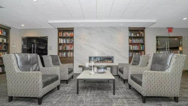 2 Bay Club Dr Unit 6Z4, Bayside, NY 11360 - living room with a drop ceiling, built in shelves, a premium fireplace, and recessed lighting