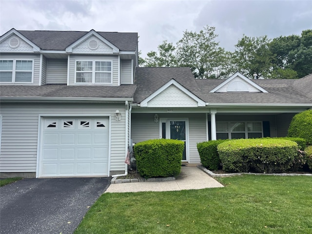 703 Pebble Beach Path, Riverhead, NY 11901 - view of front of home featuring an attached garage, a front yard, asphalt driveway, and a shingled roof