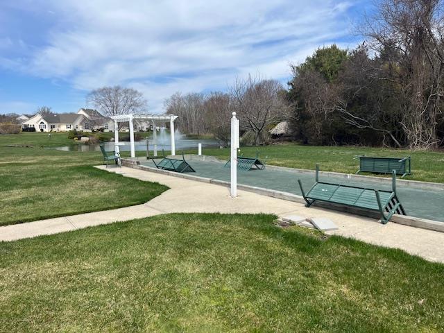 703 Pebble Beach Path, Riverhead, NY 11901 - view of property's community with a pergola, a lawn, and a water view