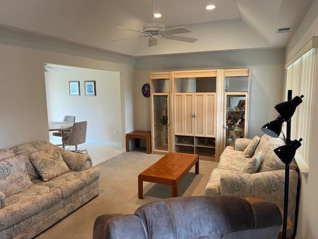 703 Pebble Beach Path, Riverhead, NY 11901 - carpeted living room with ceiling fan, a raised ceiling, and recessed lighting