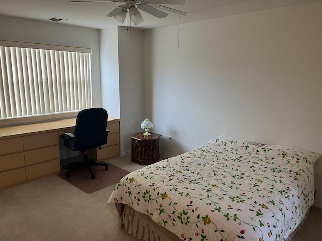 703 Pebble Beach Path, Riverhead, NY 11901 - bedroom with light colored carpet, an office area, and a ceiling fan
