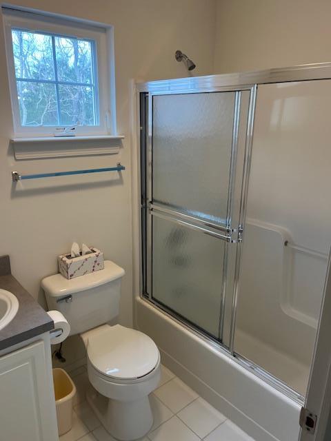 703 Pebble Beach Path, Riverhead, NY 11901 - full bath with tile patterned flooring, toilet, vanity, and shower / bath combination with glass door
