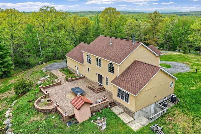 aerial view featuring a wooded view