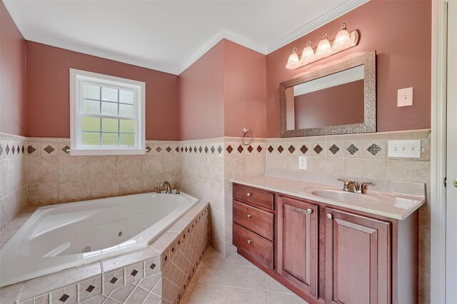 bathroom featuring tile walls, a wainscoted wall, a whirlpool tub, vanity, and tile patterned floors