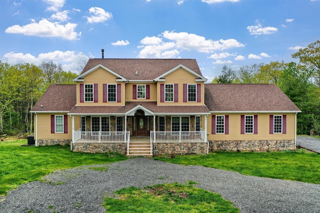 view of front of home featuring a front yard, central air condition unit, a shingled roof, and covered porch