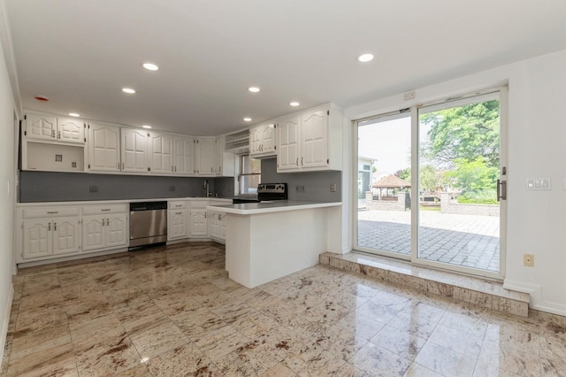 18 Oxford Rd, East Rockaway, NY 11518 - kitchen featuring stainless steel appliances, a peninsula, white cabinetry, recessed lighting, and light countertops
