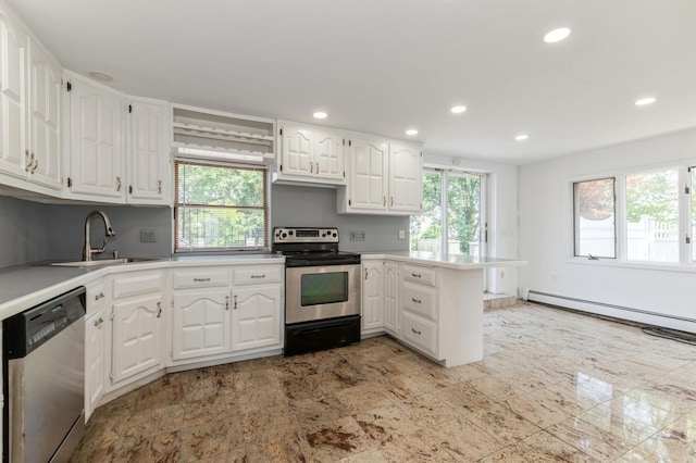 18 Oxford Rd, East Rockaway, NY 11518 - kitchen with appliances with stainless steel finishes, a peninsula, recessed lighting, white cabinets, and light countertops