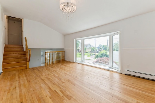 18 Oxford Rd, East Rockaway, NY 11518 - unfurnished room featuring a chandelier, wood finished floors, vaulted ceiling, a baseboard heating unit, and stairway