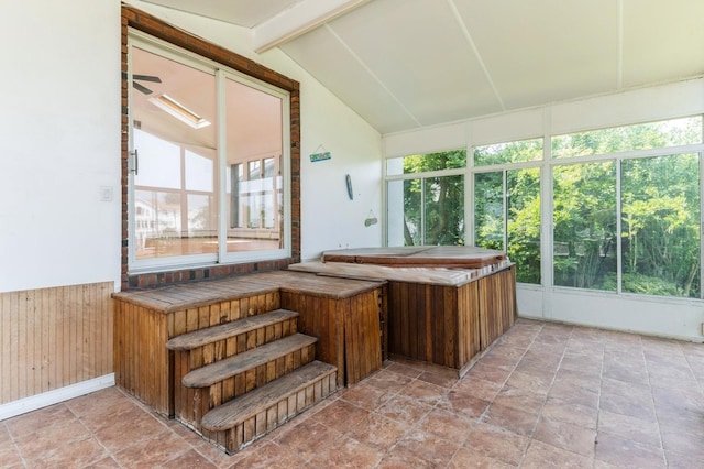 18 Oxford Rd, East Rockaway, NY 11518 - sunroom / solarium featuring a jacuzzi, a wainscoted wall, wood walls, and stone finish floors