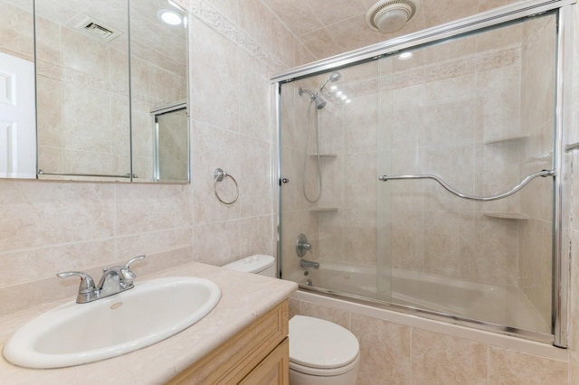 18 Oxford Rd, East Rockaway, NY 11518 - bathroom featuring tiled shower / bath combo, vanity, and tile walls