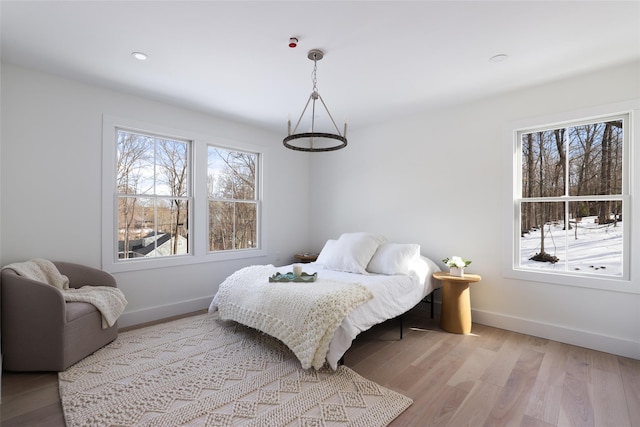 bedroom with baseboards and wood finished floors