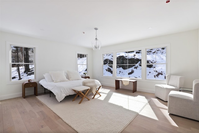 bedroom with light wood-type flooring and baseboards