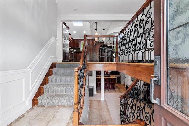 61 Beatrice Ln, Old Bethpage, NY 11804 - stairs with a decorative wall, a skylight, and a wainscoted wall