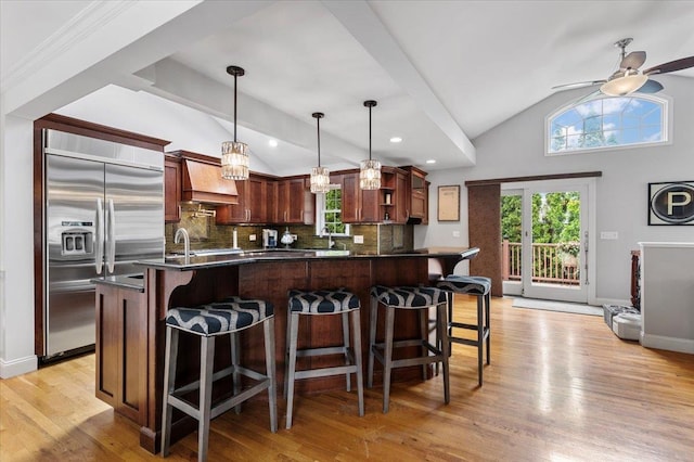 61 Beatrice Ln, Old Bethpage, NY 11804 - kitchen with stainless steel built in fridge, lofted ceiling, dark countertops, backsplash, and plenty of natural light