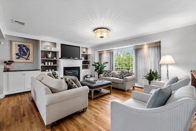 61 Beatrice Ln, Old Bethpage, NY 11804 - living area with crown molding, a glass covered fireplace, and light wood-style floors