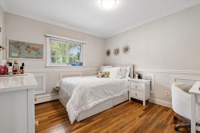 61 Beatrice Ln, Old Bethpage, NY 11804 - bedroom featuring baseboard heating, ornamental molding, wood finished floors, and wainscoting