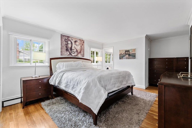 61 Beatrice Ln, Old Bethpage, NY 11804 - bedroom with light wood finished floors, multiple windows, a baseboard radiator, and ornamental molding