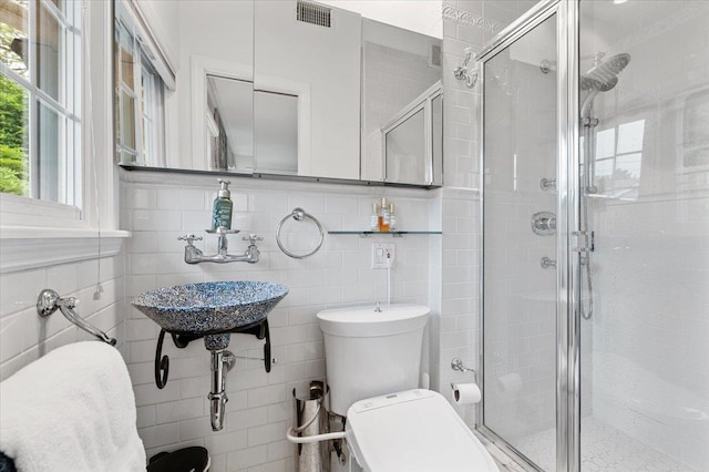 61 Beatrice Ln, Old Bethpage, NY 11804 - bathroom featuring tile walls, a shower stall, toilet, a sink, and decorative backsplash