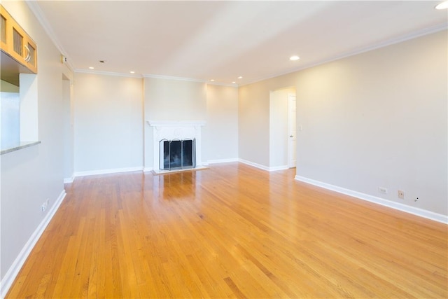 14 N Chatsworth Ave Unit 7A, Larchmont, NY 10538 - unfurnished living room with crown molding, recessed lighting, light wood-type flooring, a fireplace with raised hearth, and baseboards