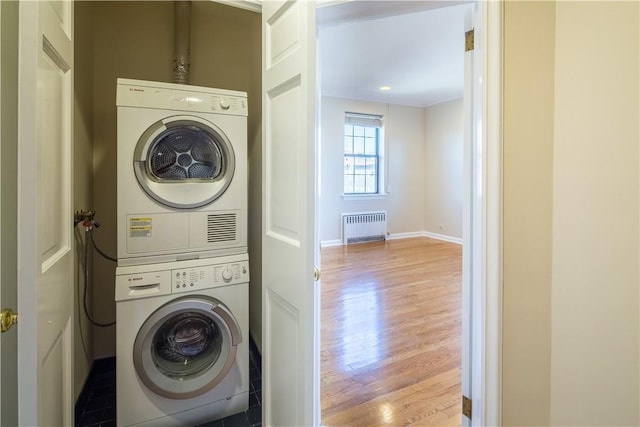 14 N Chatsworth Ave Unit 7A, Larchmont, NY 10538 - laundry area featuring radiator heating unit, estacked washer and dryer, wood finished floors, and baseboards