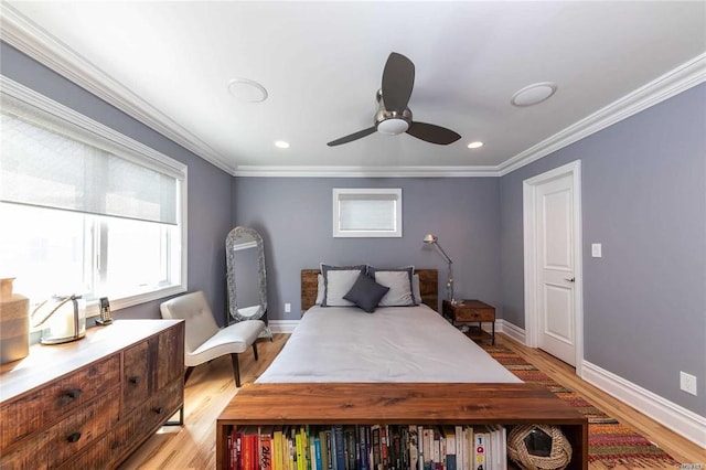 bedroom with light wood-style floors, crown molding, baseboards, and ceiling fan