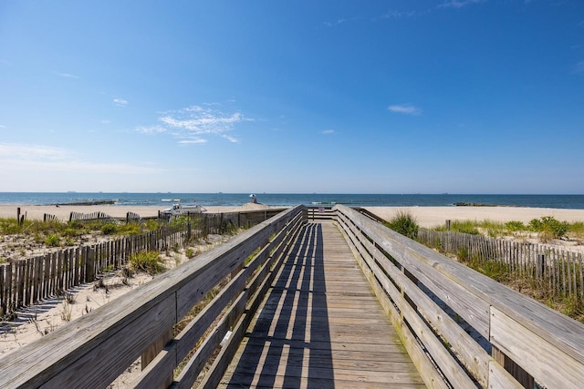 view of home's community featuring a beach view and a water view