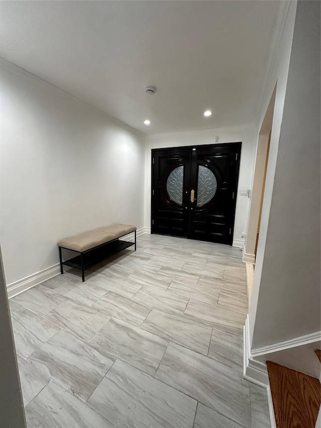 121 W Seaman Ave, Freeport, NY 11520 - entrance foyer with ornamental molding, french doors, baseboards, and recessed lighting