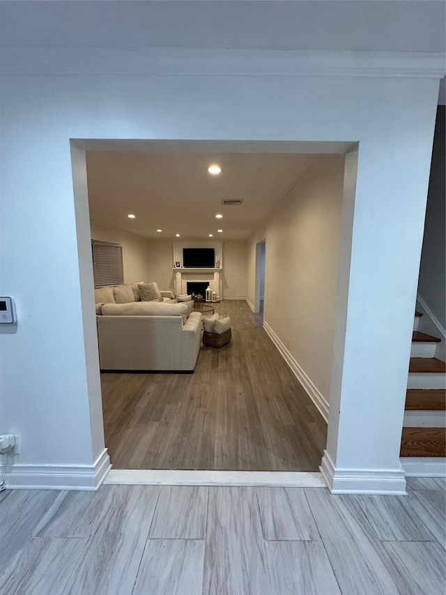 121 W Seaman Ave, Freeport, NY 11520 - living room featuring baseboards, a fireplace, stairs, visible vents, and wood finished floors