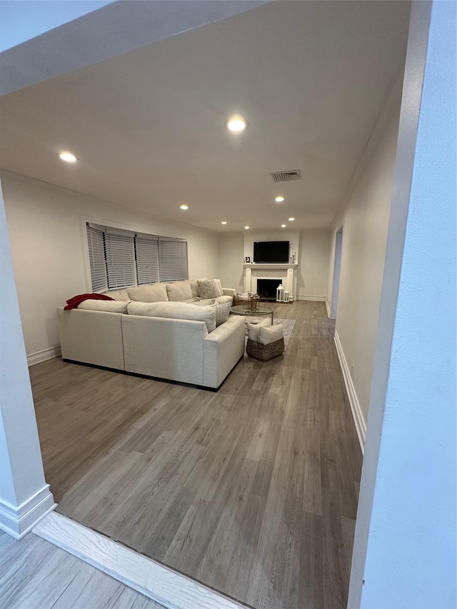 121 W Seaman Ave, Freeport, NY 11520 - living room featuring visible vents, baseboards, a fireplace, recessed lighting, and wood finished floors