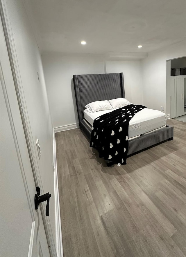 121 W Seaman Ave, Freeport, NY 11520 - bedroom featuring baseboards, recessed lighting, and wood finished floors