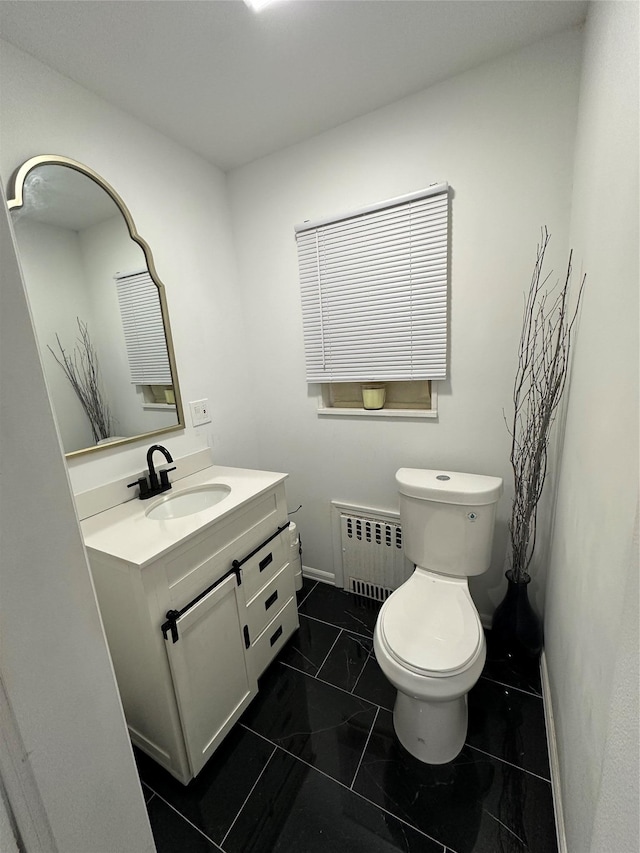 121 W Seaman Ave, Freeport, NY 11520 - bathroom featuring vanity, baseboards, toilet, radiator heating unit, and marble finish floor