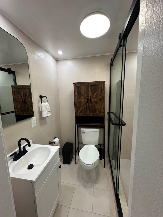 121 W Seaman Ave, Freeport, NY 11520 - bathroom with toilet, tile walls, vanity, tile patterned flooring, and a stall shower