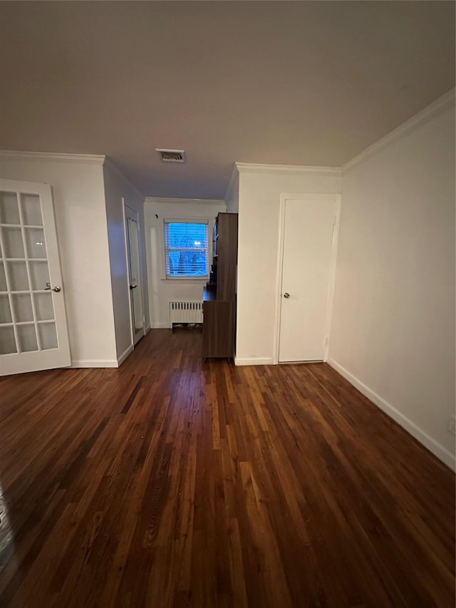 121 W Seaman Ave, Freeport, NY 11520 - unfurnished living room featuring visible vents, baseboards, ornamental molding, dark wood-style floors, and radiator heating unit