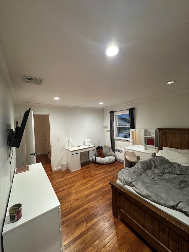 121 W Seaman Ave, Freeport, NY 11520 - bedroom featuring visible vents, radiator heating unit, recessed lighting, and wood finished floors
