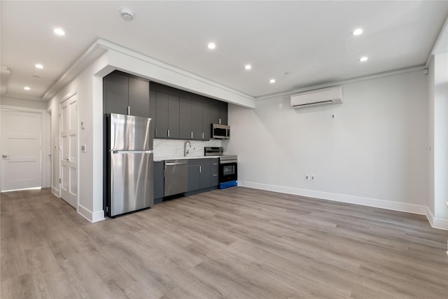 kitchen with ornamental molding, appliances with stainless steel finishes, recessed lighting, and a wall unit AC