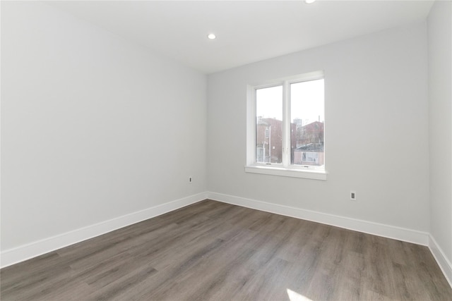 unfurnished room featuring recessed lighting, baseboards, and wood finished floors