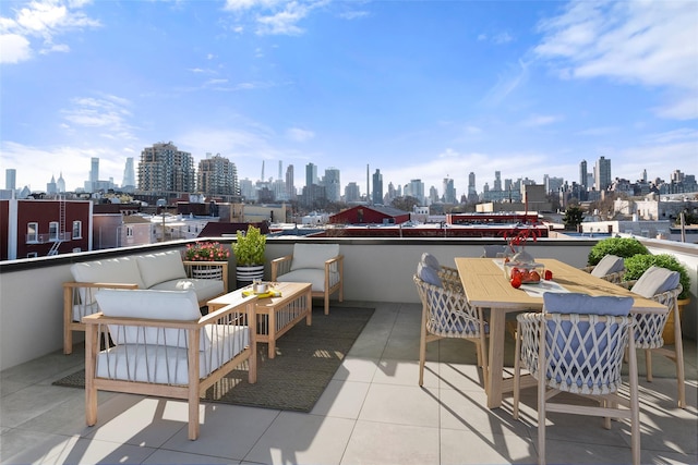 balcony with outdoor lounge area and a city view