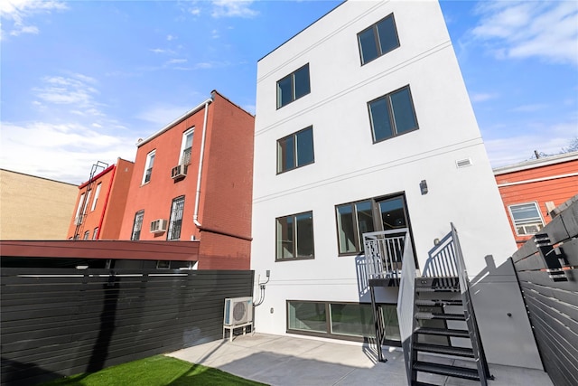 rear view of property featuring a patio area and stucco siding